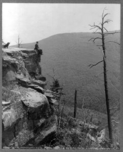Men seated on rocks overlooking Catskill Mountains- boulder on South Mountain LCCN2005688144