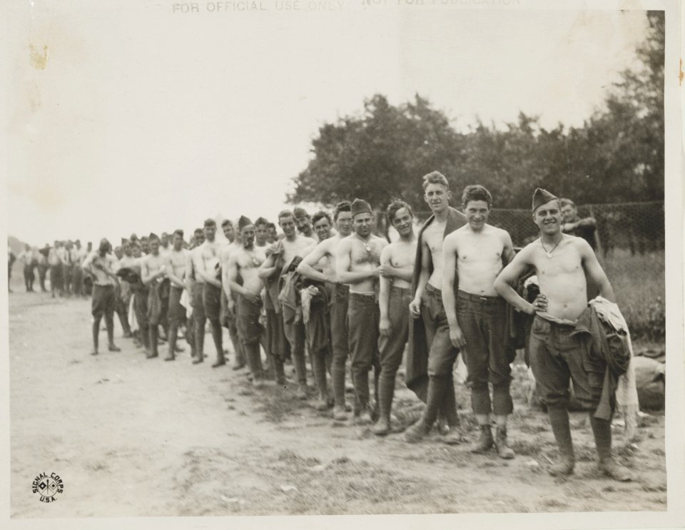Men from front lined up to turn in their clothing for replacement and disinfection at disinfecting plant no. 2, of the 26th Division The men shown here are of Battery F. 102d F.A. ... LCCN2013648399