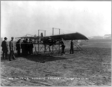 Men inspecting airplane - New Curtiss - 2 separate engines LCCN2006684407