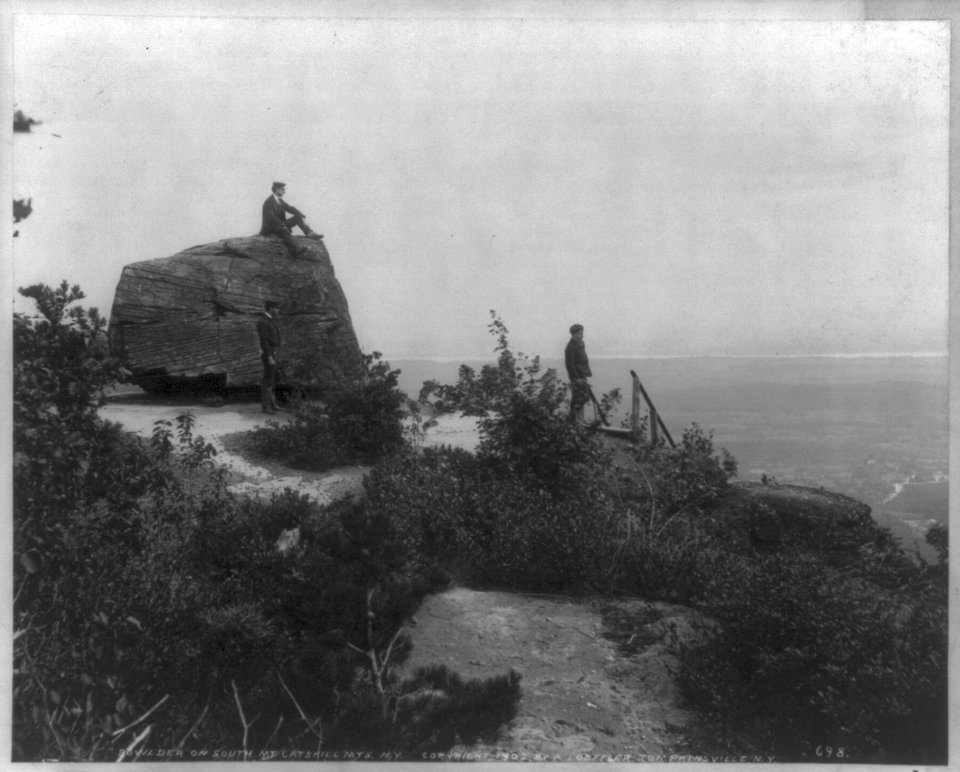 Men seated on rocks overlooking Catskill Mountains- Sunset Rock, Kaaterskill Cove LCCN2005688143