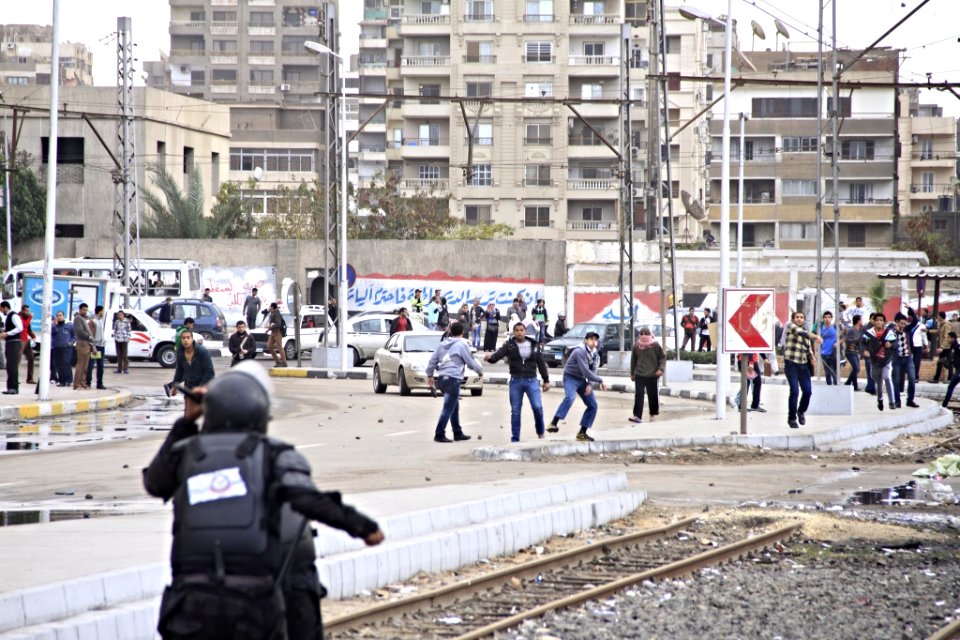 Men throwing rocks at police - protest Al-Azhar University Cairo 20-Dec-2013