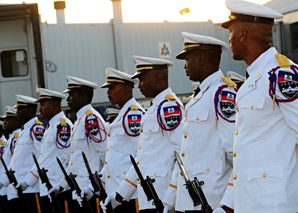 Members of the Haitian National Police Force marching band stand at parade