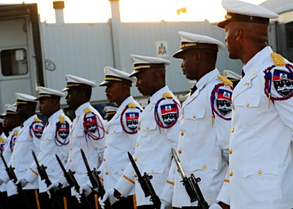 Members of the Haitian National Police Force marching band stand at parade