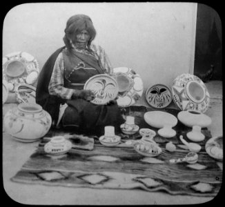 Nampeyo, Hopi pottery maker, seated, with examples of her work, 1900 - NARA - 520084 photo