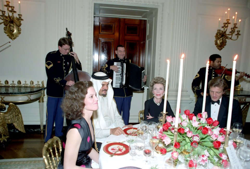 Nancy Reagan sitting with King Fahd of Saudi Arabia and Sigourney Weaver