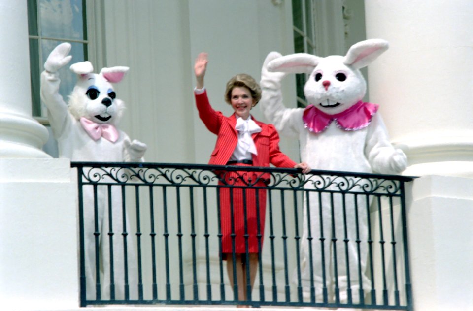 Nancy Reagan and Easter Bunnies wave from the State Floor Balcony during the White House Easter Egg Roll on the South Lawn