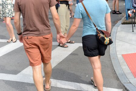 Holding hands couple walking photo