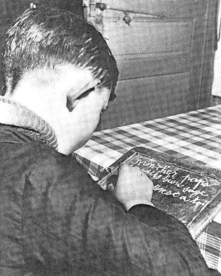 NARA - A French boy writing to his father, who is away in the army (Emmy E. Werner - Through the Eyes of Innocents)