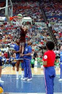 Nancy Reagan being lifted to the basket by Charles Barkley and Wayman Tisdale at a Just Say No Basketball game in Indianapolis
