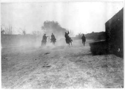 Mexican insurrectos riding away in a cloud of dust LCCN2007677280