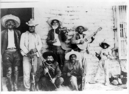 Mexican Insurrectos before the Battle of Juarez- group of Insurrectos posed with rifles, revolver, violin, and guitar LCCN2007677273