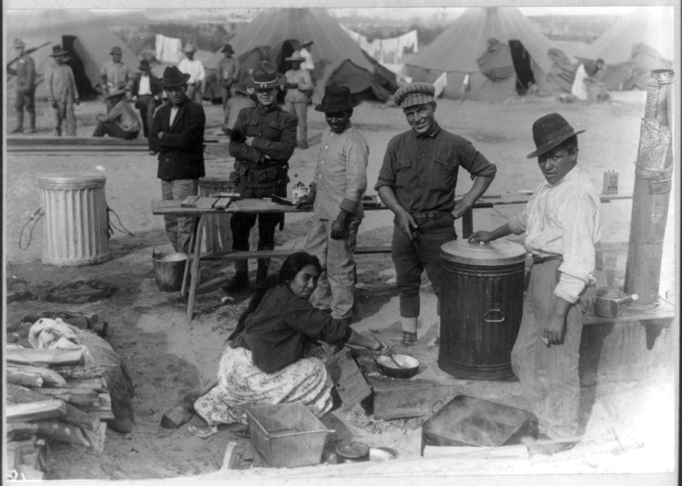Mexican men and woman assisting Army cook at U.S. Army tent camp in Mexico LCCN2006685906