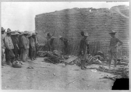 Mexican War scenes, 1914- rebels beside stacks of rifles LCCN2003655568