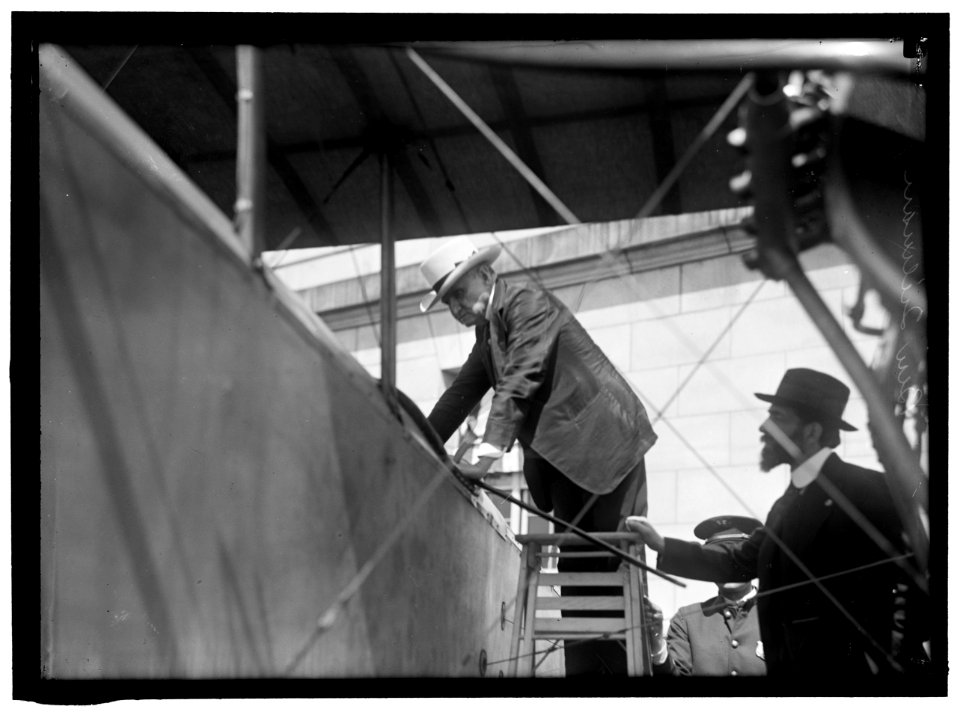 NATIONAL AERO COAST PATROL COMMN. CURTISS BIPLANE 2 ENGINES, WITH FLOATS, EXHIBITED AT S.O.B. SEN. BEN TILLMAN CLIMBING INTO PLANE; AUGUSTUS POST AT RIGHT LCCN2016865251