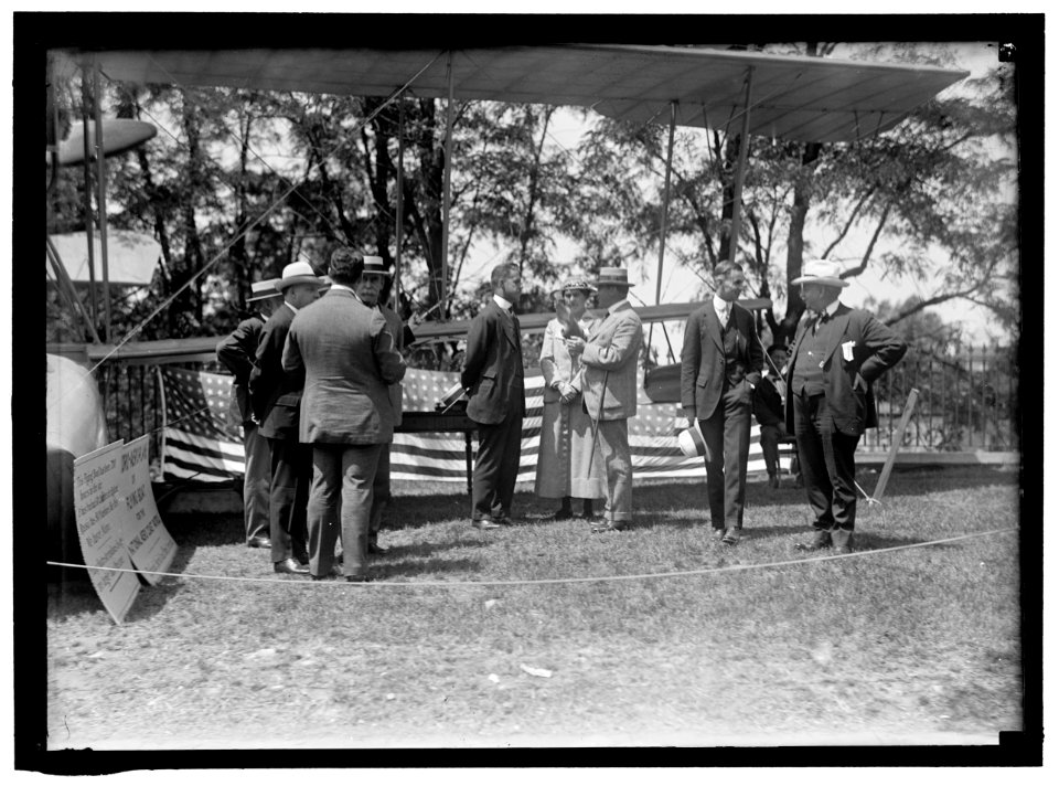 NATIONAL AERO COAST PATROL COMMN. CURTISS HYDROAEROPLANE OR FLYING BOAT EXHIBITED NEAR HOUSE OFFICE BUILDING. AT CENTER IS GROUP TOO HUDDLED TO IDENTIFY; CAPT. TAYLOR; MISS MARIE PEARY; LCCN2016865185