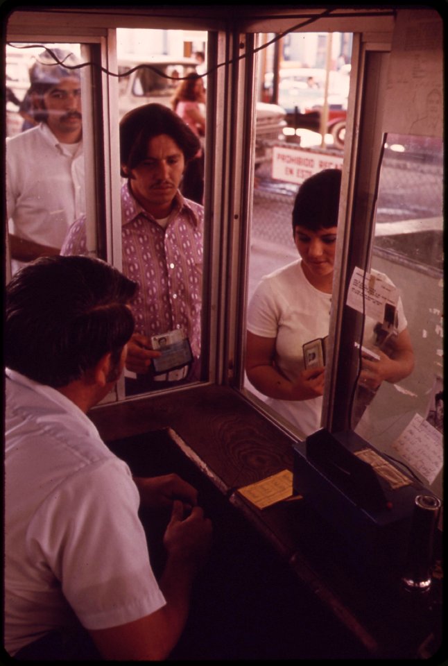 Mexican-green-card-farmworker-jugo-olivas-and-his-wife-cross-border-at-calexico-to-shop-in-american-stores-his-green-card-permits-olivas-to-work-on-farms-in-the-united-states-april-1973 7152597801 o