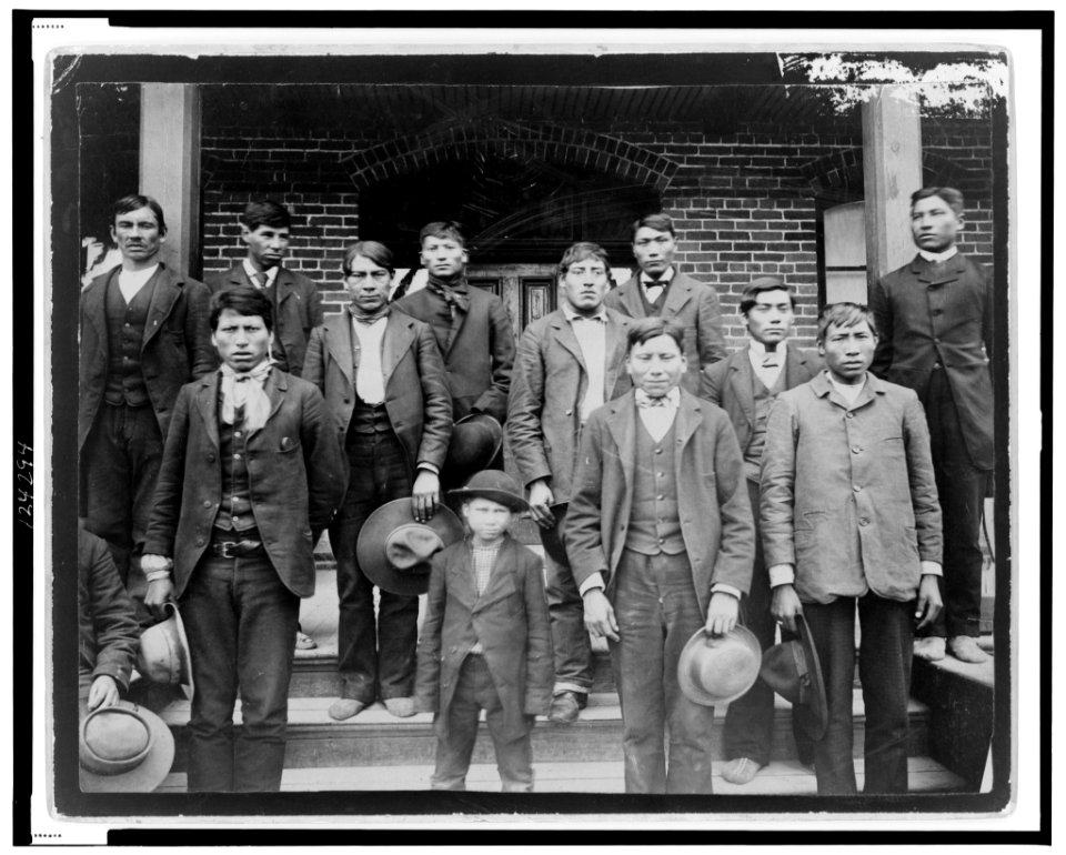 Native American men and a boy posed outside of Carlisle Indian School LCCN99471846