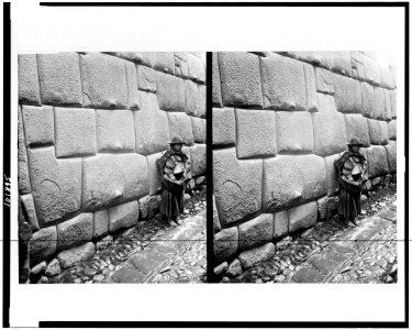 Native standing by Inca masonry wall, Cuzco, Peru LCCN90714640 photo