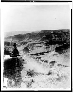 Native American seated on the edge of the Grand Canyon, Arizona LCCN90715600 photo
