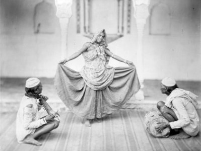 Nautch dancer with two musicians in India photo
