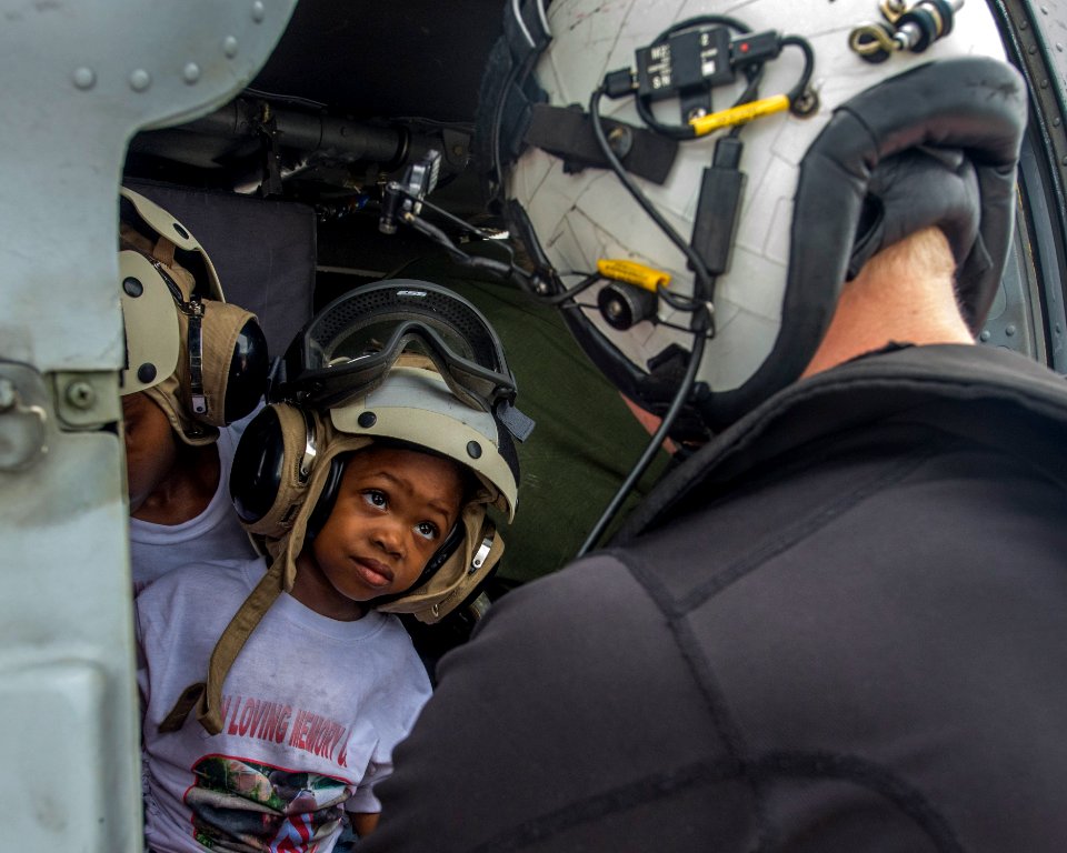 Naval Aircrewman 2nd Class Logan Parkinson prepares a patient's family for evacuation during relief efforts in the wake of Hurricane Maria (37206117232)