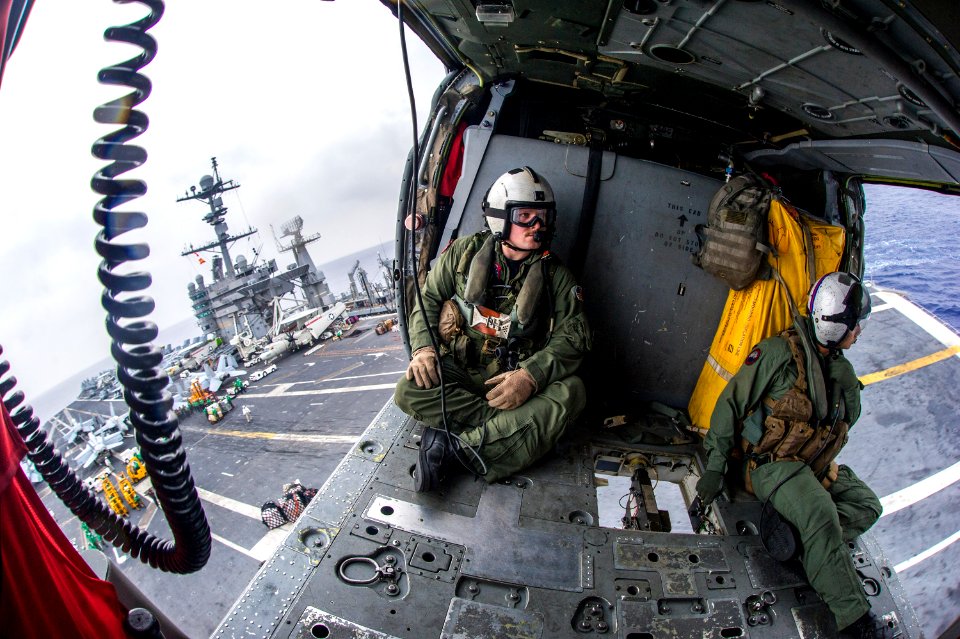 Naval aircrewmen operate a cargo hook aboard a Sea Hawk. (14384393445)
