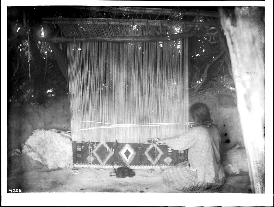 Navajo woman at her loom weaving a blanket, ca.1900 (CHS-4728)