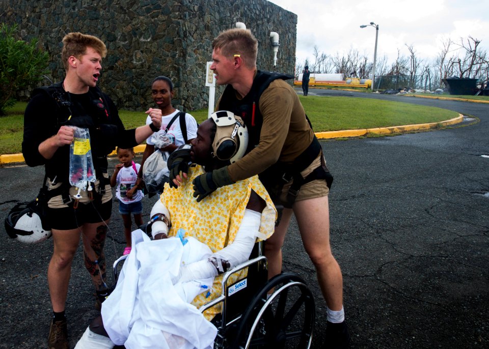 Naval Aircrewmen 2nd Class Logan Parkinson and Brandon Larnard prepare a patient for evacuation during relief efforts in the wake of Hurricane Maria (37206117952)
