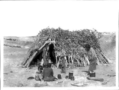 Navajo family at their hogan in Blue Canyon, ca.1900 (CHS-4733)