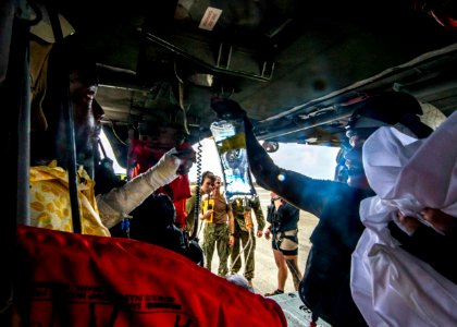 Naval Aircrewman 2nd Class Brandon Larnard prepares a patient for evacuation during relief efforts in the wake of Hurricane Maria (37206116552)