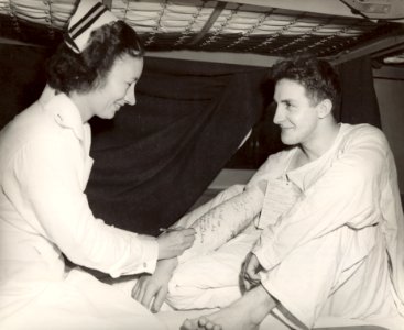 Navy nurse signing cast -- WWII photo