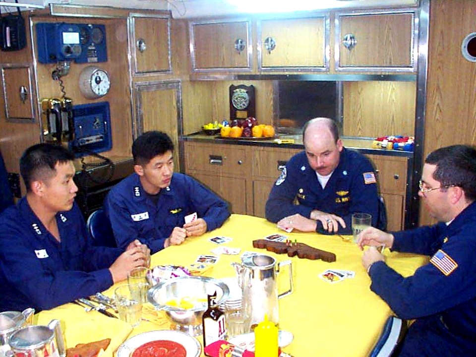 Navy officers learning cribbage