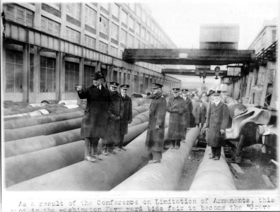 Navy Secretary Edwin Denby and staff touring Washington Navy Yard, inspecting large guns for battleships yet to be built LCCN2005686569
