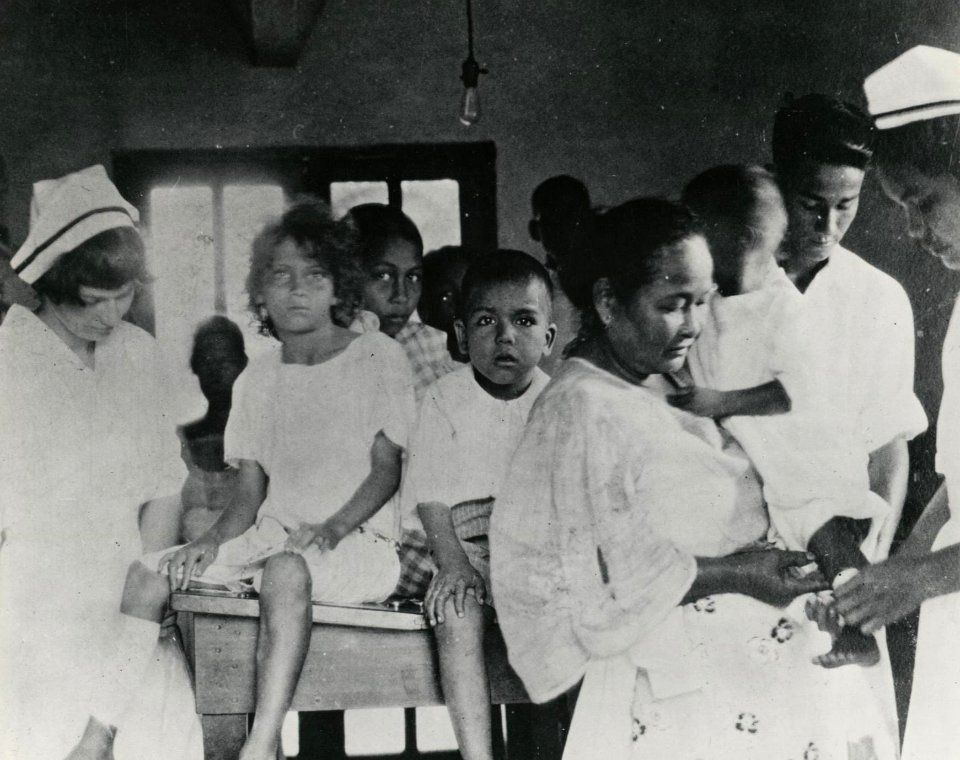 Navy nurses rendering aid in Guam -- 1940s