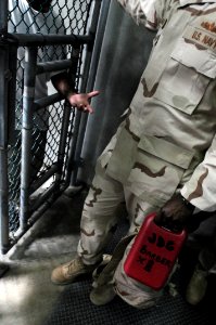 Navy barber meets with a detainee DVIDS367050