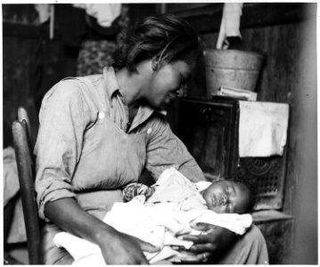 Near Buckeye, Maricopa County, Arizona. Migrant (African-American) cotton picker and her baby. - NARA - 522540