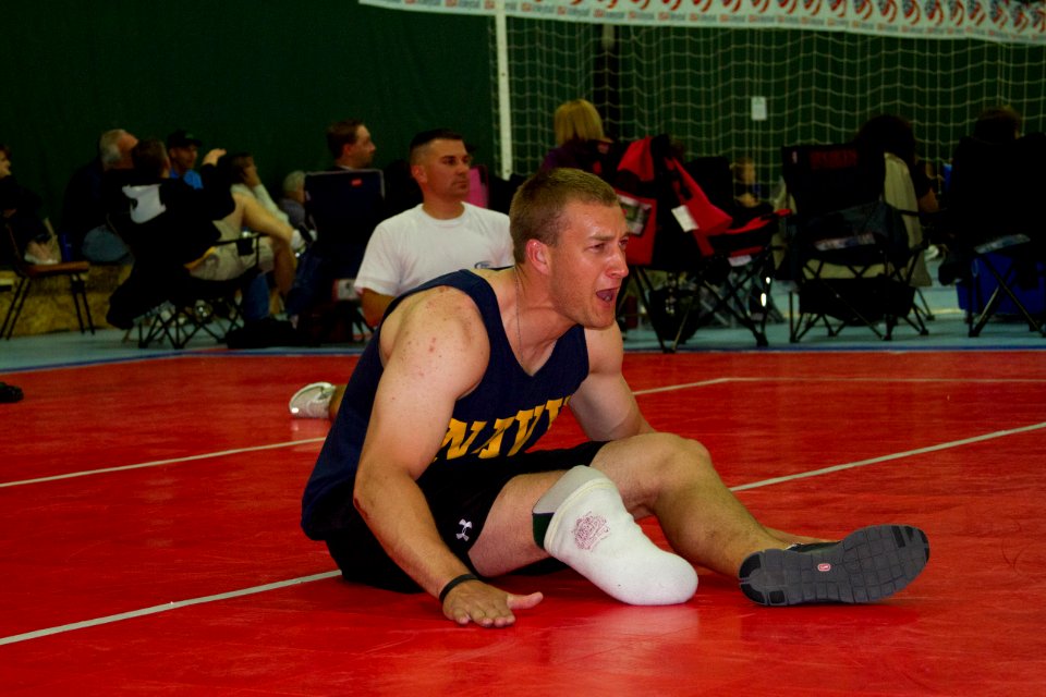 Navy Hospital Corpsman Max Rohn encourages teammates during a game of sitting volleyball while training for the 2012 Warrior Games. 120428-N-AN499-183