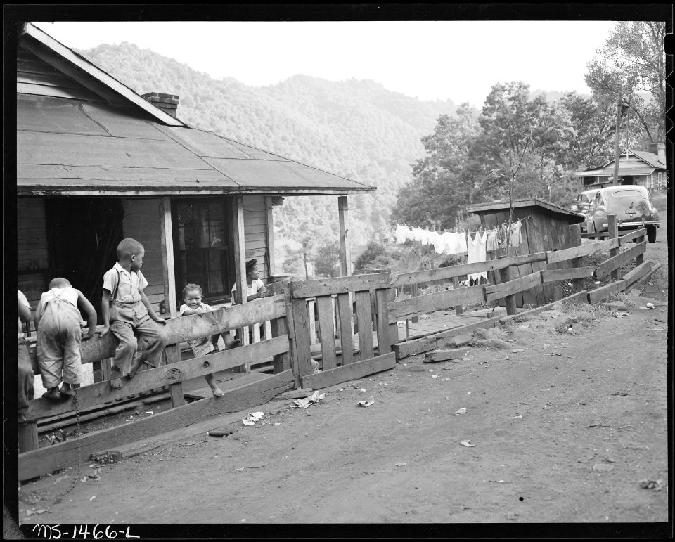 Neighboring children play with the Howard children on the fence in front of the Howard house. Gilliam Coal and Coke... - NARA - 540806