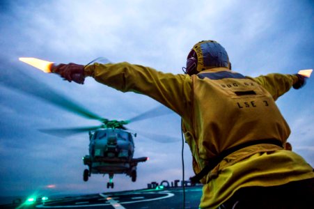 MH-60 Seahawk launches from USS Fitzgerald 150425-N-XM324-479