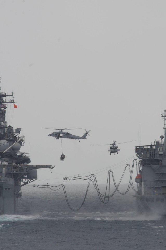 MH-60S Seahawk helicopters transfer supplies during a vertical replenishment between the amphibious assault ship USS Boxer (LHD 4), left, and the fleet replenishment oiler USNS Rappahannock (T-AO 204) March 17 110317-N-RC734-208