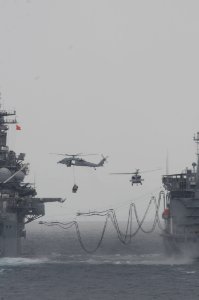 MH-60S Seahawk helicopters transfer supplies during a vertical replenishment between the amphibious assault ship USS Boxer (LHD 4), left, and the fleet replenishment oiler USNS Rappahannock (T-AO 204) March 17 110317-N-RC734-208