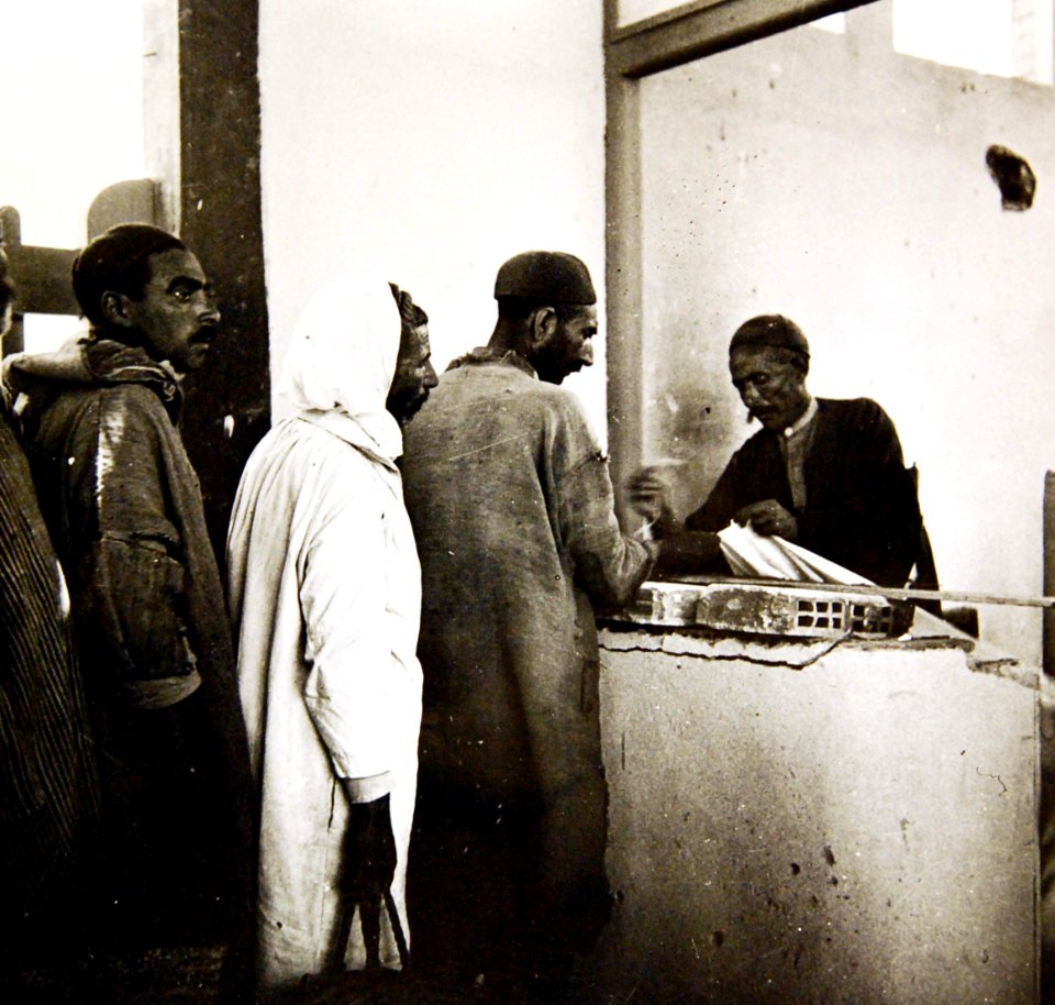 Middle Eastern men getting textiles at market, Mejez-El-Bab, Tunisia, 1943 (35486748665)