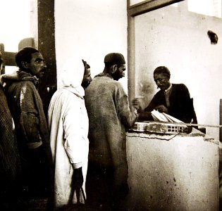 Middle Eastern men getting textiles at market, Mejez-El-Bab, Tunisia, 1943 (35486748665) photo