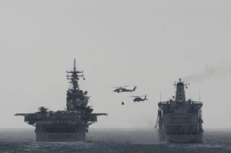 MH-60S Seahawk helicopters transfer supplies during a vertical replenishment between the amphibious assault ship USS Boxer (LHD 4), left, and the fleet replenishment oiler USNS Rappahannock (T-AO 204) March 17 110317-N-RC734-183