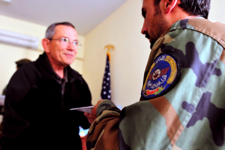 Michael A Benz gives a graduation certificate to an Afghan National Army soldier (4543190504)