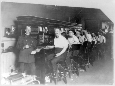 New York (City) Police Dept., 1909- telephone operators (men) lined up at police headquarters switchboard LCCN2007678224