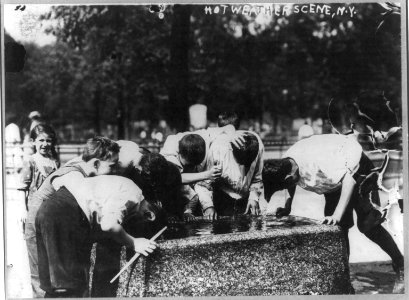 New York City - children on the street- hot weather street scene - boys dipping their heads in fountain LCCN2003656075