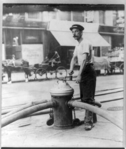 New York City fireman turning on high pressure hoses at hydrant. July 1908 LCCN2007682983