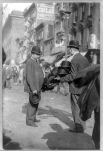 New York City street peddler; man peddling derby hats LCCN2016648986