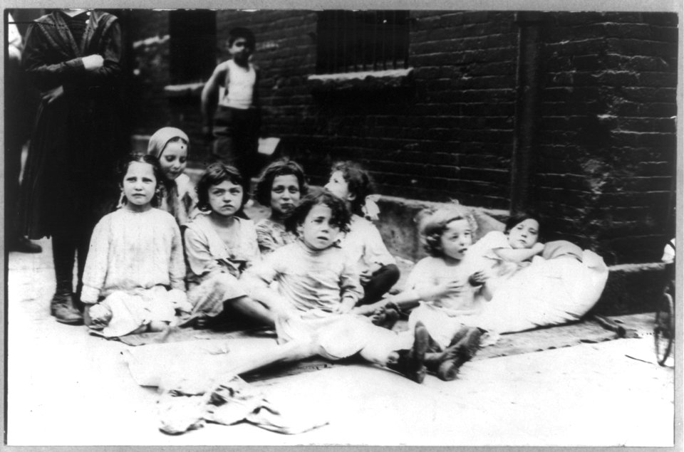 New York City - children on the street- children seated on pavement LCCN2003656074